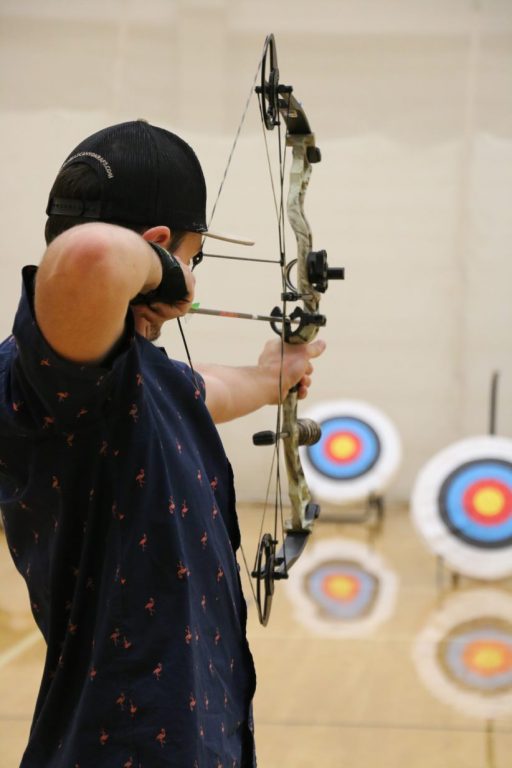 Student about to shoot the bow at a target