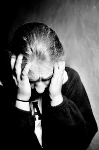 Stressed out student standing with hands around her face