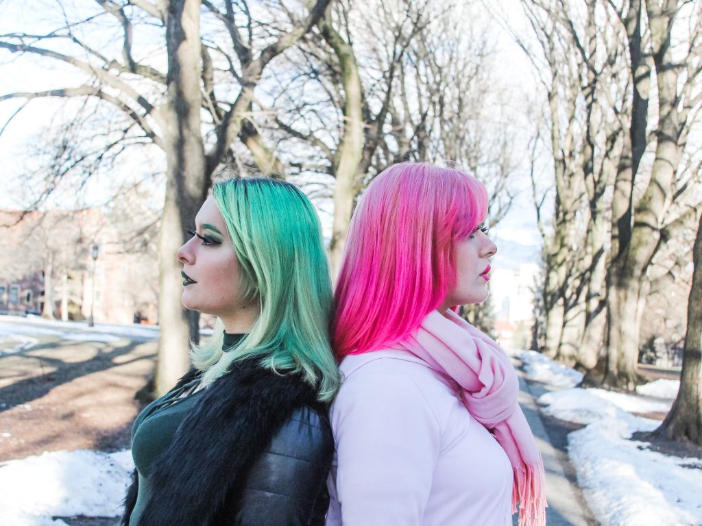 Ali and Josie Jones posing with their backs together in the Admin.