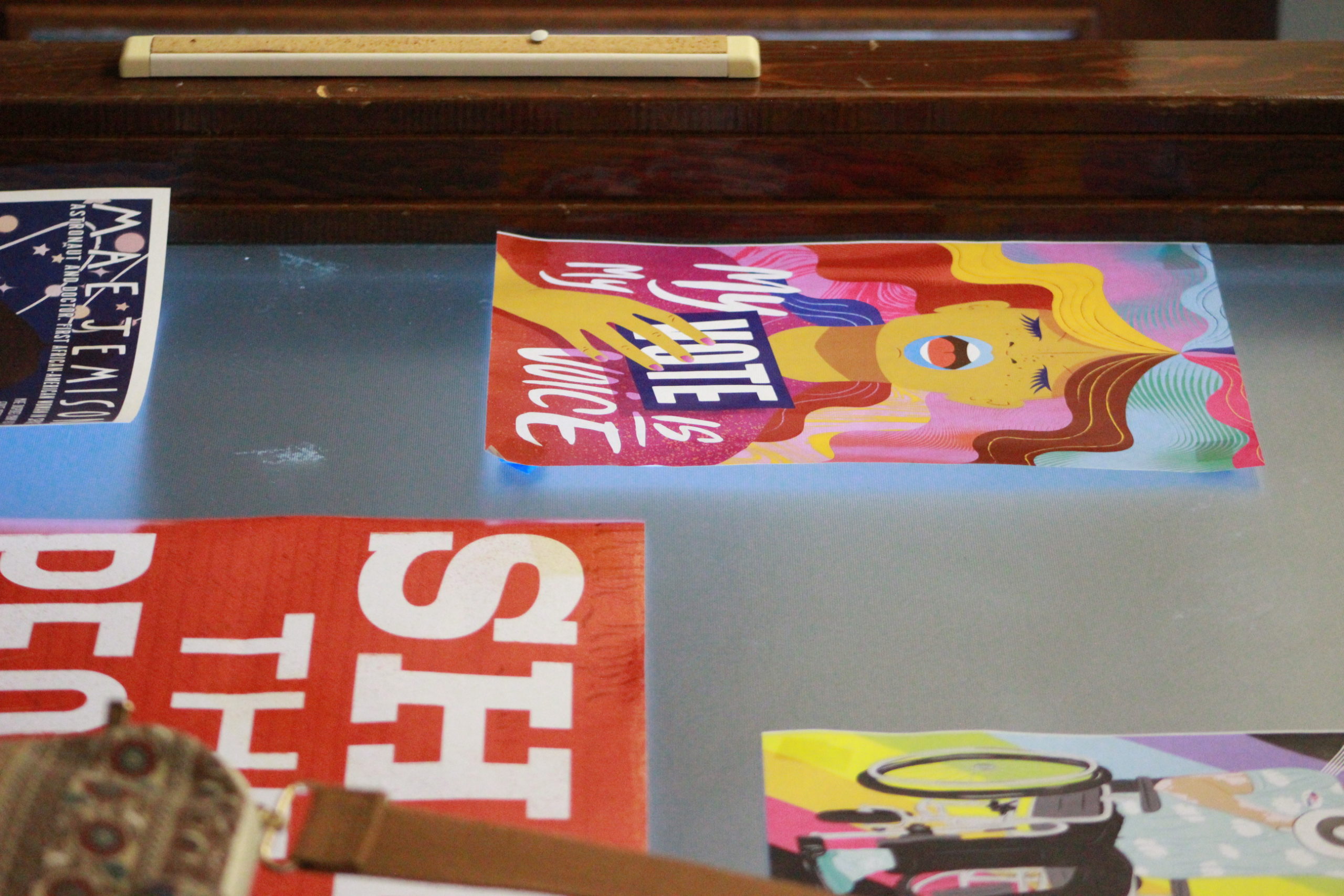 A variety of posters decorates the walls outside the entrance to the Women’s Center, some of them advertisements and others offering words of encouragement.  